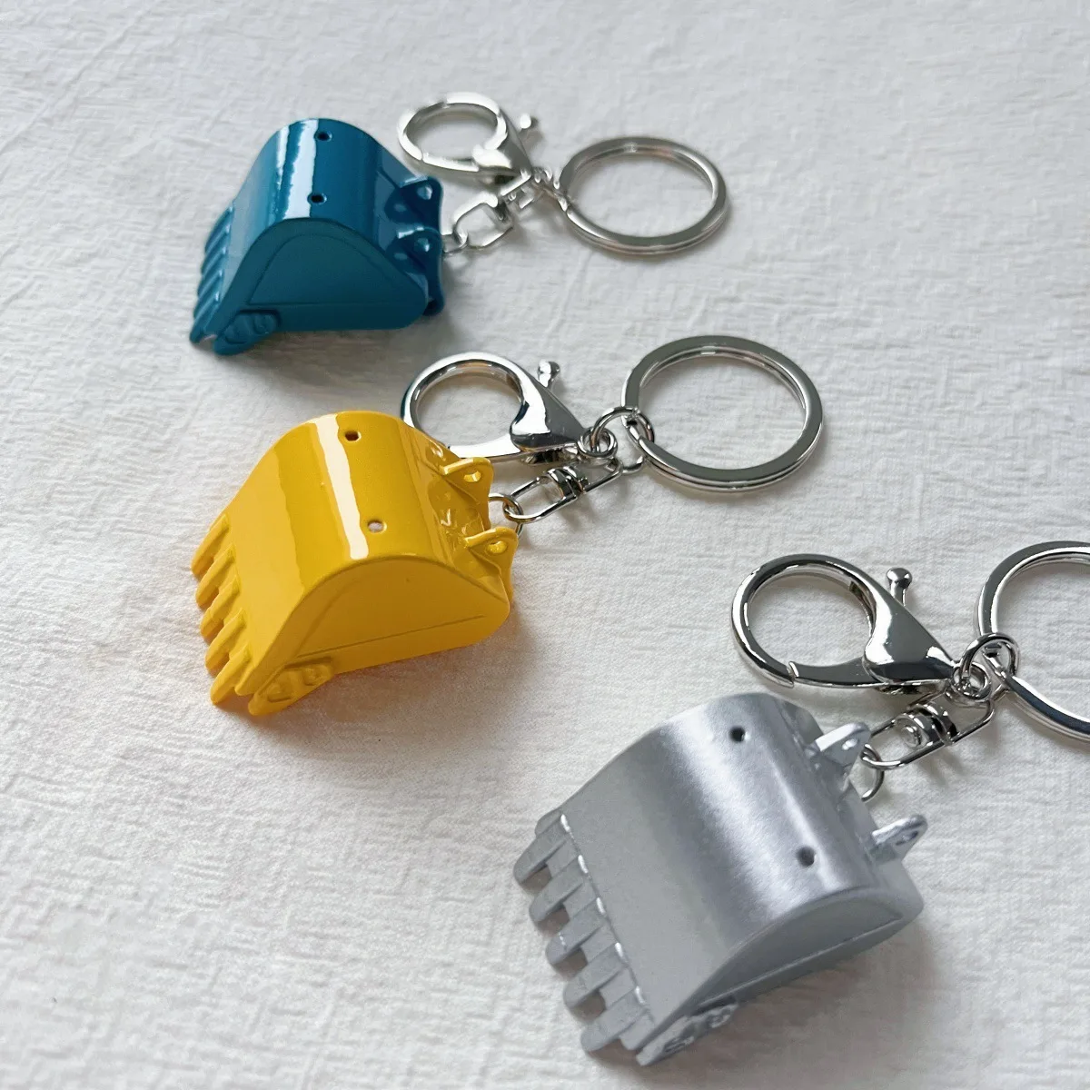 Porte-clés métallique en forme de pelle excavatrice